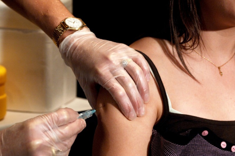Menina toma vacina no braço